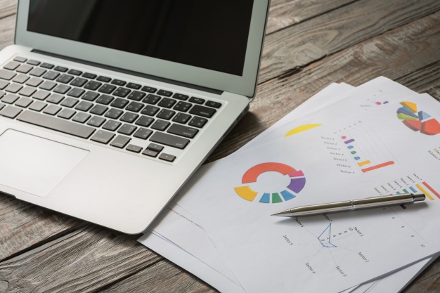 laptop-with-colorful-business-documents_1232-821